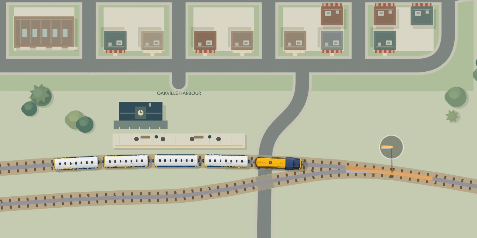 Milk Run's yellow locomotive and passenger coaches at Oakville Harbour, with a parallel siding, track switch, station and trees.